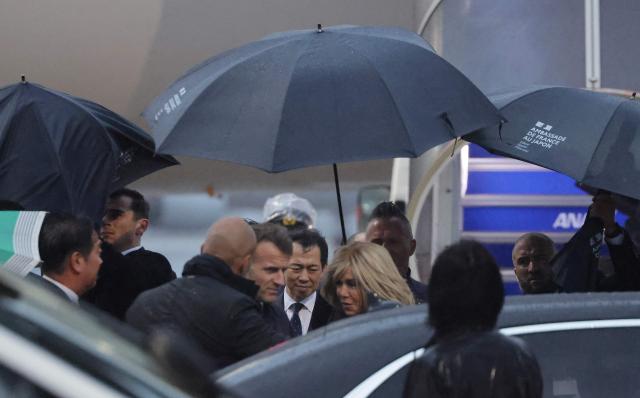 France's President Emmanuel Macron (center-L) and his wife Brigitte arrives at Tokyo Haneda International Airport in Tokyo on march 31, 2026. (Photo by Ludovic MARIN / AFP)