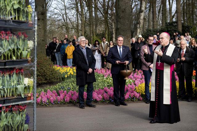 Rotterdam Bishop Johannes van den Hende, president of the Episcopal Conference of the Netherlands, blesses flowers selected for the Easter decoration of St. Peter's Square at the Keukenhof flower park in Lisse, as part of a 40-year tradition of the Netherlands supplying flowers to the Vatican, on March 31, 2026. (Photo by Ramon van Flymen / ANP / AFP) / Netherlands OUT