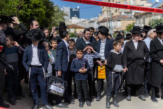 Ultra-Orthodox Jews stand looking towards the damage at a site hit during an Iranian strike over Bnei Brak in central Israel on March 31, 2026. Iran fired missiles across the Middle East on March 31 as its capital was hit by fresh explosions, after US President Donald Trump threatened the country's key oil export hub, power stations and desalination plants. (Photo by Ilia YEFIMOVICH / AFP) / 
