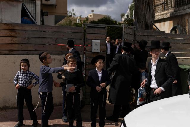 Ultra-Orthodox Jewish residents gather at a site hit during an Iranian strike over Bnei Brak in central Israel on March 31, 2026. Iran fired missiles across the Middle East on March 31 as its capital was hit by fresh explosions, after US President Donald Trump threatened the country's key oil export hub, power stations and desalination plants. (Photo by Ilia YEFIMOVICH / AFP) / 