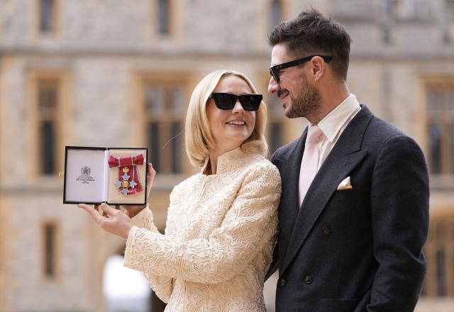 British Actress Carey Mulligan alongside her husband Marcus Mumford poses with her medal after being appointed a Commander of the Order of the British Empire (CBE) at an investiture ceremony at Windsor Castle, west of London on March 31, 2026. (Photo by Andrew Matthews / POOL / AFP)