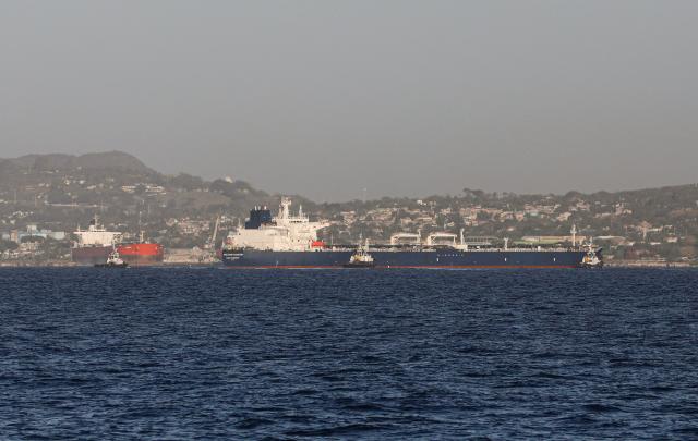 The Russian oil tanker Anatoly Kolodkin (R) arrives at the oil terminal in the port of Matanzas, northwestern Cuba, early on March 31, 2026. The Anatoly Kolodkin, a tanker under US sanctions carrying 730,000 barrels of crude, is set to deliver the first crude shipment to Cuba since January after Washington gave the crisis-hit island a reprieve from an effective fuel blockade. (Photo by AFP)