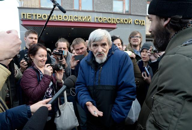 (FILES) Russian historian Yury Dmitriyev, who heads rights group Memorial's branch in Karelia, speaks to the media outside a court building following the verdict in his child pornography trial in the city of Petrozavodsk in northwestern Russia on April 5, 2018. Europe's top rights court condemned on March 31, 2026 Russia for violating jailed Gulag historian Yury Dmitriyev's rights to short pre-trial detention and a fair hearing, but did not rule his jailing was politically motivated. (Photo by OLGA MALTSEVA / AFP)