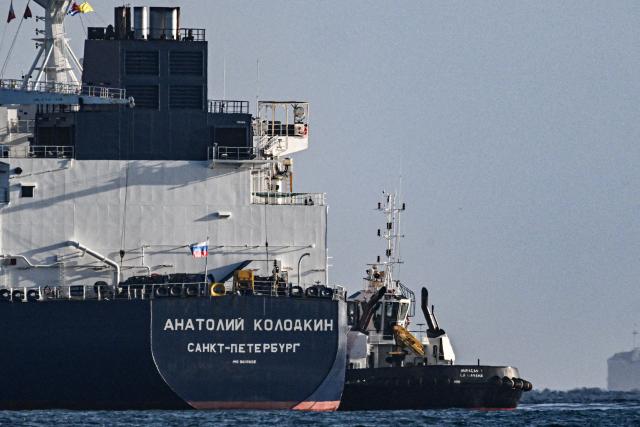 A tugboat guides the Russian oil tanker Anatoly Kolodkin at the oil terminal in the port of Matanzas, northwestern Cuba, on March 31, 2026. The Anatoly Kolodkin, a tanker under US sanctions carrying 730,000 barrels of crude, is set to deliver the first crude shipment to Cuba since January after Washington gave the crisis-hit island a reprieve from an effective fuel blockade. (Photo by Yamil LAGE / AFP)