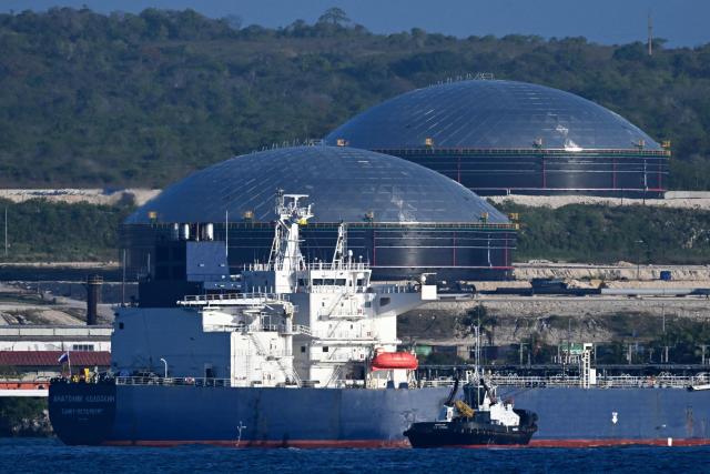 A tugboat guides the Russian oil tanker Anatoly Kolodkin at the oil terminal in the port of Matanzas, northwestern Cuba, on March 31, 2026. The Anatoly Kolodkin, a tanker under US sanctions carrying 730,000 barrels of crude, is set to deliver the first crude shipment to Cuba since January after Washington gave the crisis-hit island a reprieve from an effective fuel blockade. (Photo by Yamil LAGE / AFP)
