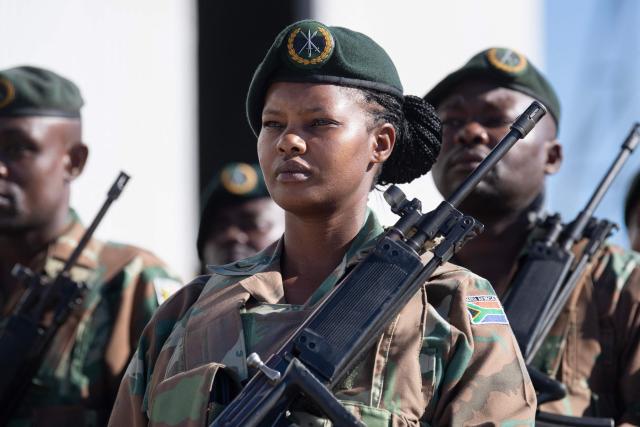 Members of the South African National Defence Force (SANDF) and the South African Police Service (SAPS) (unseen) take part in a parade in Belhar in Cape Town on March 31, 2026. This parade forms the final part of the preparations for the SANDF to play a supporting role to the SAPS in crime prevention operations, under the name of Operation Prosper. (Photo by RODGER BOSCH / AFP)