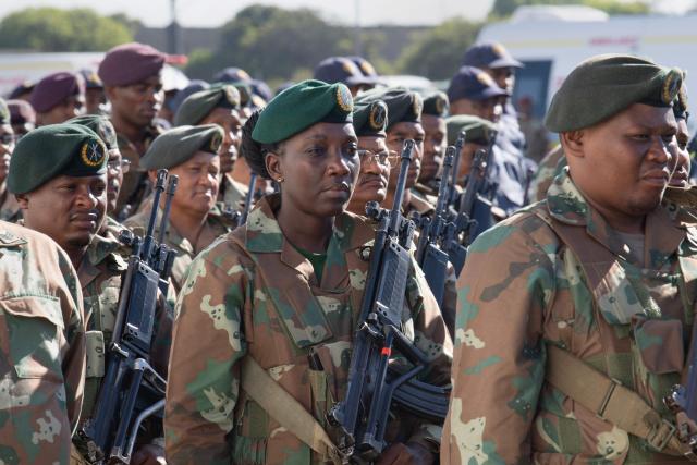 Members of the South African National Defence Force (SANDF) and the South African Police Service (SAPS) (unseen) take part in a parade in Belhar in Cape Town on March 31, 2026. This parade forms the final part of the preparations for the SANDF to play a supporting role to the SAPS in crime prevention operations, under the name of Operation Prosper. (Photo by RODGER BOSCH / AFP)