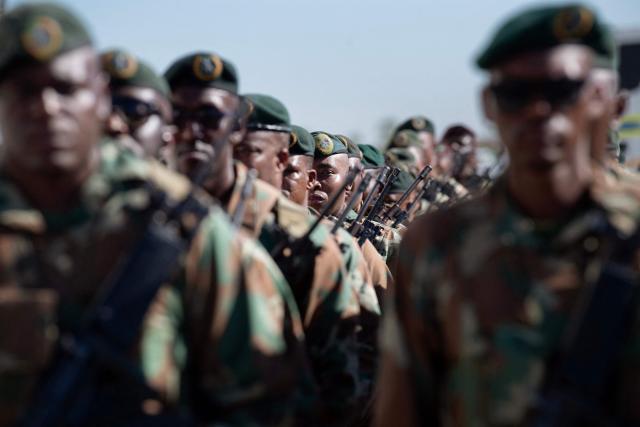Members of the South African National Defence Force (SANDF) and the South African Police Service (SAPS) (unseen) take part in a parade in Belhar in Cape Town on March 31, 2026. This parade forms the final part of the preparations for the SANDF to play a supporting role to the SAPS in crime prevention operations, under the name of Operation Prosper. (Photo by RODGER BOSCH / AFP)
