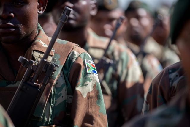 Members of the South African National Defence Force (SANDF), and the South African Police Service (SAPS) (unseen) take part in a parade in Belhar in Cape Town on March 31, 2026. This parade forms the final part of the preparations for the SANDF to play a supporting role to the SAPS in crime prevention operations, under the name of Operation Prosper. (Photo by RODGER BOSCH / AFP)
