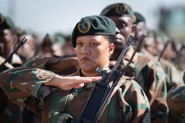 Members of the South African National Defence Force (SANDF), and the South African Police Service (SAPS) (unseen) take part in a parade in Belhar in Cape Town on March 31, 2026. This parade forms the final part of the preparations for the SANDF to play a supporting role to the SAPS in crime prevention operations, under the name of Operation Prosper. (Photo by RODGER BOSCH / AFP)