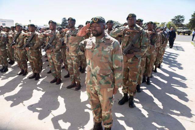 Members of the South African National Defence Force (SANDF), and the South African Police Service (SAPS) (unseen) take part in a parade in Belhar in Cape Town on March 31, 2026. This parade forms the final part of the preparations for the SANDF to play a supporting role to the SAPS in crime prevention operations, under the name of Operation Prosper. (Photo by RODGER BOSCH / AFP)
