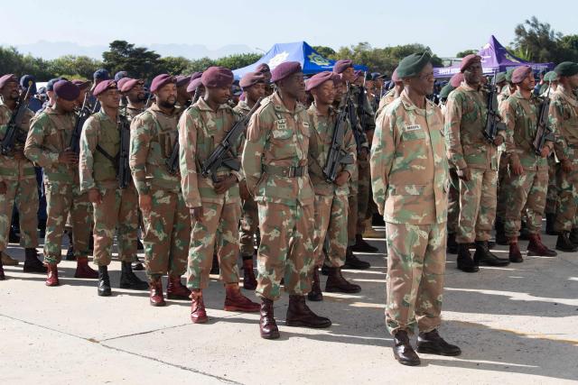 Members of the South African National Defence Force (SANDF) the South African Police Service (SAPS) and Cape Town Metro Law Enforcement take part in a parade in Belhar in Cape Town on March 31, 2026. This parade forms the final part of the preparations for the SANDF to play a supporting role to the SAPS in crime prevention operations, under the name of Operation Prosper. (Photo by RODGER BOSCH / AFP)