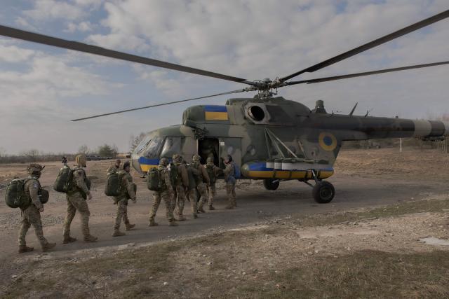 Ukrainian servicemen of Air Assault Forces board a Mi-8 helicopter to conduct parachute jumps training, at a training center, in an undisclosed location on March 27, 2026, amid the Russian invasion of Ukraine. The Air Assault Forces is a separate branch of the Armed Forces of Ukraine, whose main purpose is to rapidly respond to military threats and conduct swift offensive and defensive operations. It was specifically Air Assault units that were among the first to be deployed in operations such as the Kursk operation and the Kharkiv counteroffensive. Ukraine is preparing key changes to the mobilisation process, along with improved contracts and pay for infantry and assault troops, in an effort to recruit more people into the army. (Photo by Roman PILIPEY / AFP)