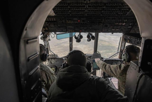 Ukrainian military pilots fly a Mi-8 helicopter as servicemen of Air Assault Forces conduct parachute jumps training, in an undisclosed location on March 27, 2026, amid the Russian invasion of Ukraine. The Air Assault Forces is a separate branch of the Armed Forces of Ukraine, whose main purpose is to rapidly respond to military threats and conduct swift offensive and defensive operations. It was specifically Air Assault units that were among the first to be deployed in operations such as the Kursk operation and the Kharkiv counteroffensive. Ukraine is preparing key changes to the mobilisation process, along with improved contracts and pay for infantry and assault troops, in an effort to recruit more people into the army. (Photo by Roman PILIPEY / AFP)