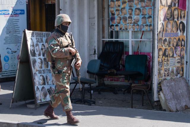 A member of the South African National Defence Force (SANDF) walks through Mfuleni township in Cape Town on March 31, 2026. This is part of the preparations for the SANDF to play a supporting role to the South African Police Service(SAPS) in crime prevention operations, under the name of Operation Prosper. (Photo by RODGER BOSCH / AFP)