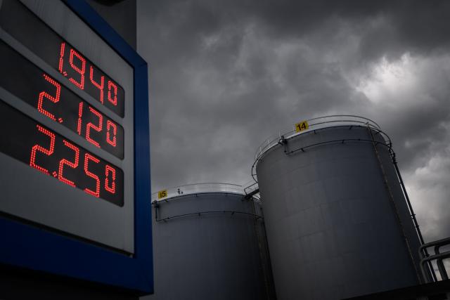 This photograph shows the prices per litre of petrol and diesel fuels at a petrol station next to gasoline and fuel tanks in Geneva on March 31, 2026. US and European stocks rose on March 31, 2026, on hopes for a quick end to the Middle East war, while oil prices steadied amid the continuing uncertainty. (Photo by Fabrice COFFRINI / AFP)