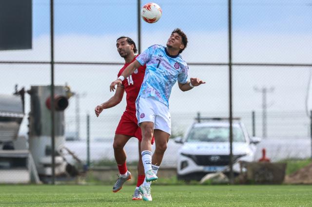 Iran's midfielder #14 Saman Ghoddos heads the ball next to Costa Rica's midfielder #7 Andy Rojas during a friendly football match between Iran and Costa Rica, in Antalya, southern Turkey, on March 31, 2026. FIFA's president told AFP that Iran "will be at the World Cup" despite the Middle East war. (Photo by Adem ALTAN / AFP)