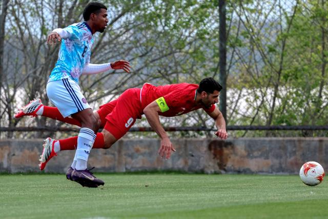 Costa Rica's defender #8 Gerald Taylor fauls Iran's forward #9 Mehdi Taremi in the penalty areaduring a friendly football match between Iran and Costa Rica, in Antalya, southern Turkey, on March 31, 2026. FIFA's president told AFP that Iran "will be at the World Cup" despite the Middle East war. (Photo by Adem ALTAN / AFP)