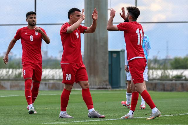 Iran's forward #18 Amirhossein Hosseinzadeh celebrates with his teammates after scoring a goal during a friendly football match between Iran and Costa Rica, in Antalya, southern Turkey, on March 31, 2026. FIFA's president told AFP that Iran "will be at the World Cup" despite the Middle East war. (Photo by Adem ALTAN / AFP)