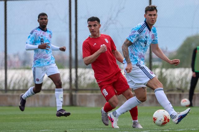 Iran's forward #18 Amirhossein Hosseinzadeh vies for the ball with Costa Rica's defender #4 Juan Pablo Vargas during a friendly football match between Iran and Costa Rica, in Antalya, southern Turkey, on March 31, 2026. FIFA's president told AFP that Iran "will be at the World Cup" despite the Middle East war. (Photo by Adem ALTAN / AFP)
