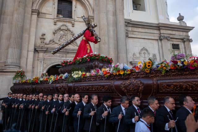 Catholic faithful carry an image of Jesus Christ during the procession of La Resena, as part of Holy Week in Guatemala City on March 31, 2026. (Photo by Edwin Bercian / AFP)