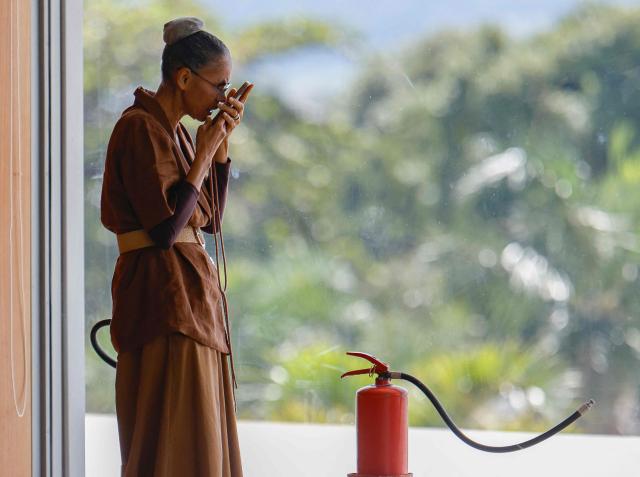Brazil’s Environment Minister Marina Silva uses her cellphone before President Lula’s speech during a ministerial meeting at the Palacio do Planalto in Brasilia, Brazil, on March 31, 2026. (Photo by Sergio Lima / AFP)