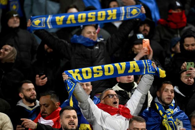 Supporters of Kosovo national football team hold scarves ahead of the FIFA World Cup 2026 European qualification final football match between Kosovo and Turkey at the Fadil Vokrri stadium in Pristina on March 31, 2026. (Photo by Armend NIMANI / AFP)