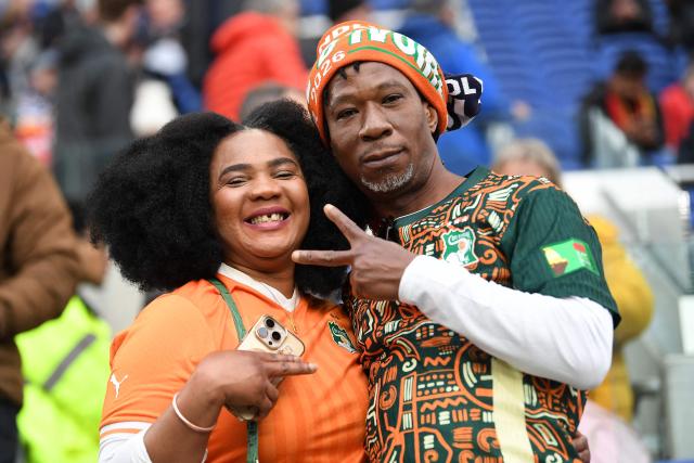 Ivory Coast fans pose for a picture ahead of the friendly international football match between Scotland and Ivory Coast at the Hill Dickinson Stadium in Liverpool, north west England on March 31, 2026.  (Photo by PETER POWELL / AFP)