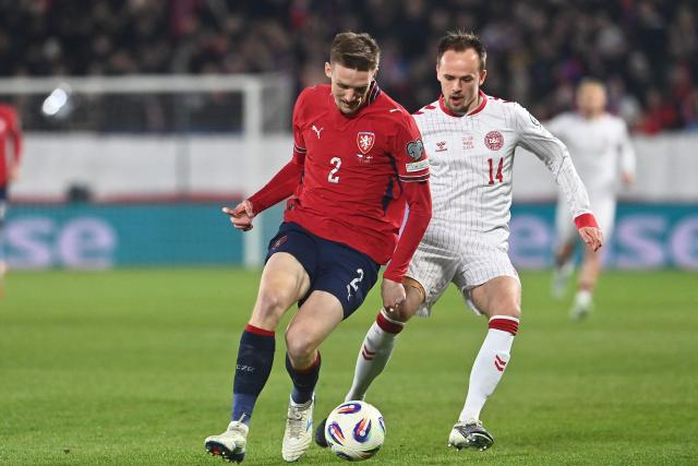 Czech Republic's defender #02 Stepan Chaloupek (L) and Denmark's forward #14 Mikkel Damsgaard (R) vie for the ball during the FIFA World Cup 2026 European qualification final football match Czech Republic vs Denmark on March 31, 2026 in Prague, Czech Republic. (Photo by Michal Cizek / AFP)