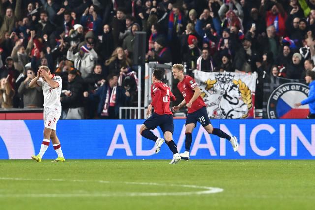 Czech Republic's midfielder #08 Vladimir Darida (C) and Czech Republic's defender #20 Jaroslav Zeleny (R) celebrate the team's opening goal 1-0 as Denmark's forward #08 Gustav Isaksen (L) reacts during the FIFA World Cup 2026 European qualification final football match Czech Republic vs Denmark on March 31, 2026 in Prague, Czech Republic. (Photo by Michal Cizek / AFP)