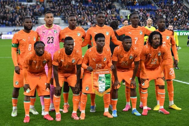 (Back row L-R) Ivory Coast's midfielder #08 Franck Kessié, Ivory Coast's goalkeeper #23 Alban Lafont, Ivory Coast's defender #05 Wilfried Singo, Ivory Coast's defender #02 Ousmane Diomande, Ivory Coast's defender #07 Odilon Kossounou and Ivory Coast's forward #26 Nicolas Pépé, (Front row L-R) Ivory Coast's forward #11 Bénie Traoré, Ivory Coast's defender #03 Ghislain Konan, Ivory Coast's midfielder #19 Christ Inao Oulaï, Ivory Coast's forward #24 Bazoumana Touré and Ivory Coast's forward #12 Elye Wahi pose for a team photo ahead of the friendly international football match between Scotland and Ivory Coast at the Hill Dickinson Stadium in Liverpool, north west England on March 31, 2026.  (Photo by PETER POWELL / AFP)