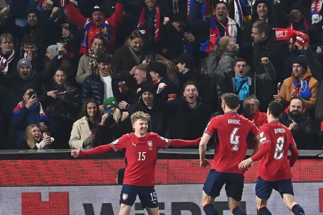 Czech Republic's midfielder #15 Pavel Sulc (L) celebrates scoring the opening goal 1-0 during the FIFA World Cup 2026 European qualification final football match Czech Republic vs Denmark on March 31, 2026 in Prague, Czech Republic. (Photo by Michal Cizek / AFP)