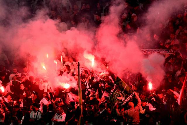 Algeria’s supporters light flares as they cheer their team on from the stands during the friendly international football match between Algeria and Uruguay at the Allianz Stadium in Turin on March 31, 2026. (Photo by MARCO BERTORELLO / AFP)