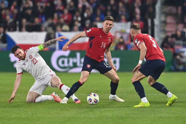 Czech Republic's midfielder #14 Lukas Provod (C) with Denmark's defender #05 Joakim Maehle (R) vie for the ball with Denmark's midfielder #23 Pierre-Emile Hojbjerg (L) during the FIFA World Cup 2026 European qualification final football match Czech Republic vs Denmark on March 31, 2026 in Prague, Czech Republic. (Photo by Michal Cizek / AFP)
