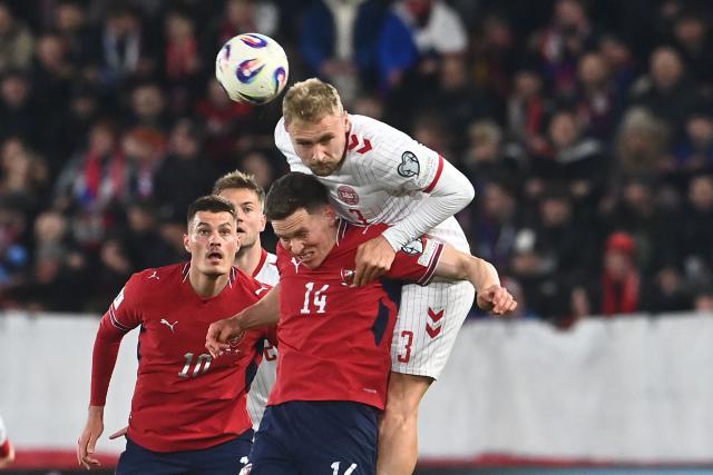 Denmark's defender #03 Victor Nelsson (R) and Czech Republic's midfielder #14 Lukas Provod (2nd R) vie for a header as Czech Republic's forward #10 Patrik Schick  looks up during the FIFA World Cup 2026 European qualification final football match Czech Republic vs Denmark on March 31, 2026 in Prague, Czech Republic. (Photo by Michal Cizek / AFP)