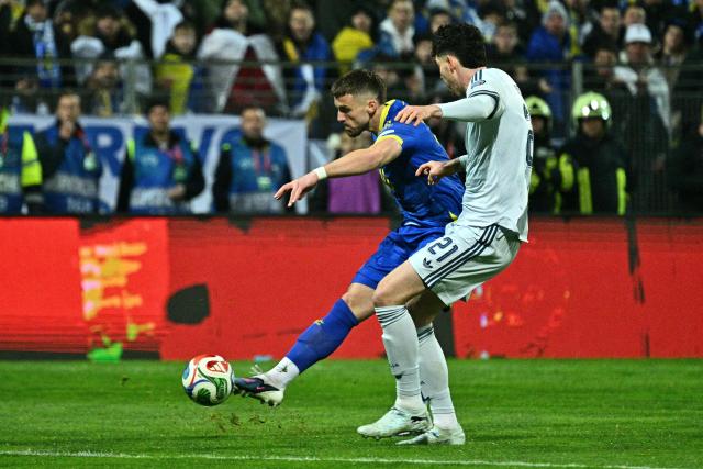 Bosnia-Herzegovina's forward #10 Ermedin Demirovic (L) fights for the ball with Italy's defender #21 Alessandro Bastoni during the FIFA World Cup 2026 European qualification final football match between Bosnia-Herzegovina and Italy at the Bilino-Polje stadium in Zenica on March 31, 2026. (Photo by Elvis BARUKCIC / AFP)