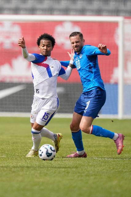 Haiti's forward #15 Ruben Providence (L) and Iceland's midfielder #10 Gylfi Sigurdsson vie for the ball during a friendly football match between Haiti and Iceland at BMO Field in Toronto, Ontario, on March 31, 2026. (Photo by Geoff Robins / AFP)