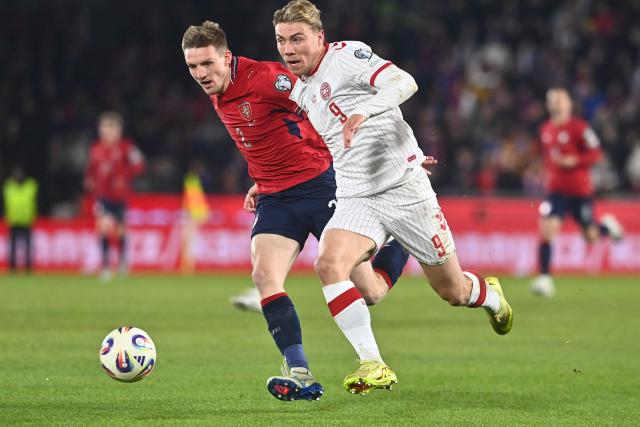Czech Republic's defender #02 Stepan Chaloupek (L) and Denmark's forward #09 Rasmus Hoejlund vie for the ball during the FIFA World Cup 2026 European qualification final football match Czech Republic vs Denmark on March 31, 2026 in Prague, Czech Republic. (Photo by Michal Cizek / AFP)