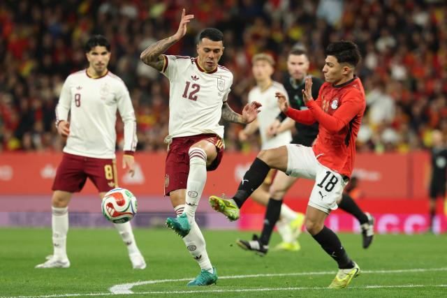 Spain's defender #12 Pedro Porro Sauceda (L) challenges Egypt's forward #18 Islam Issa during the international friendly football match between Spain and Egypt at RCDE Stadium in Cornella de Llobregat, near Barcelona, on March 31, 2026. (Photo by Lluis GENE / AFP)