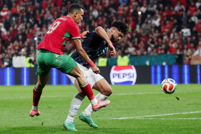 Morocco's Soufiane Rahimi (L) fights for the ball with Paraguay's Omar Alderete during the friendly football match between Marocco and Uruguay at the Stade Bollaert-Delelis in Lens, northern France on March 31, 2026. (Photo by Francois LO PRESTI / AFP)