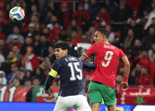 Morocco's Soufiane Rahimi (R) fights for the ball with Paraguay's Gustavo Gomez during the friendly football match between Morocco and Paraguay at the Stade Bollaert-Delelis in Lens, northern France on March 31, 2026. (Photo by Francois LO PRESTI / AFP)