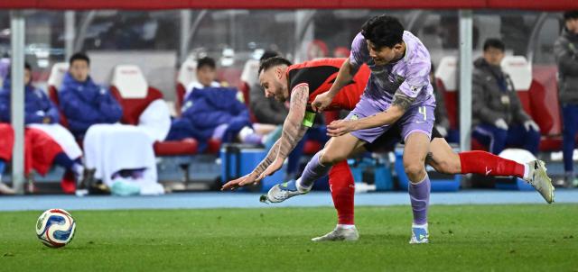 Austria's midfielder #06 Nicolas Seiwald (L) and South Korea's defender #04 Kim Min-jae  vie for the ball during a friendly football match between Austria and South Korea in Vienna, Austria, on March 31, 2026. (Photo by Joe Klamar / AFP)