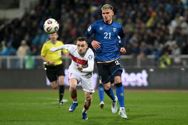 Turkey's forward #07 Kerem Akturkoglu (L) and Kosovo's defender #21 Albian Hajdari fight for the ball during the FIFA World Cup 2026 European qualification final football match between Kosovo and Turkey at the Fadil Vokrri stadium in Pristina on March 31, 2026. (Photo by Armend NIMANI / AFP)