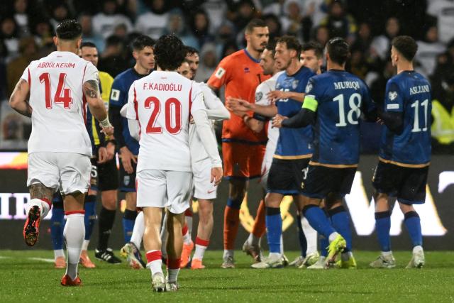 Turkey's defender #14 Abdulkerim Bardakci (L) runs towards his teammates during the FIFA World Cup 2026 European qualification final football match between Kosovo and Turkey at the Fadil Vokrri stadium in Pristina on March 31, 2026. (Photo by Armend NIMANI / AFP)