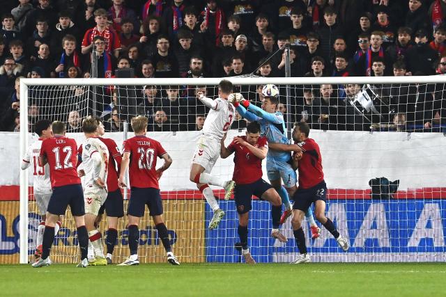 Denmark's defender #02 Joachim Andersen (4th R) jumps to score the equalizing goal 1-1 during the FIFA World Cup 2026 European qualification final football match Czech Republic vs Denmark on March 31, 2026 in Prague, Czech Republic. (Photo by Michal Cizek / AFP)