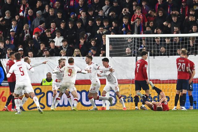 Denmark's defender #02 Joachim Andersen (C) celebrates with team mates after scoring the equalizing goal 1-1 during the FIFA World Cup 2026 European qualification final football match Czech Republic vs Denmark on March 31, 2026 in Prague, Czech Republic. (Photo by Michal Cizek / AFP)