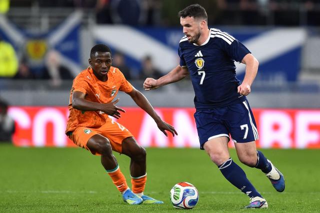 Scotland's midfielder #07 John McGinn (R) runs with the ball during the friendly international football match between Scotland and Ivory Coast at the Hill Dickinson Stadium in Liverpool, north west England on March 31, 2026.  (Photo by PETER POWELL / AFP)