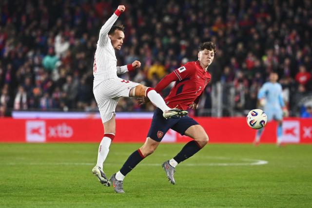 Denmark's defender #04 Lucas Hogsberg (L) and Czech Republic's defender #07 Ladislav Krejci vie for the ball during the FIFA World Cup 2026 European qualification final football match Czech Republic vs Denmark on March 31, 2026 in Prague, Czech Republic. (Photo by Michal Cizek / AFP)