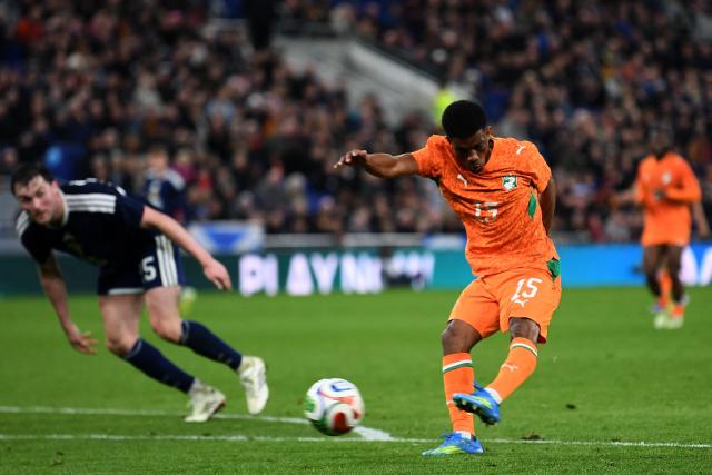 Ivory Coast's forward #15 Amad Diallo has this shot saved during the friendly international football match between Scotland and Ivory Coast at the Hill Dickinson Stadium in Liverpool, north west England on March 31, 2026.  (Photo by PETER POWELL / AFP)