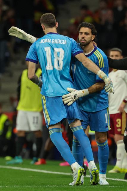Spain's goalkeeper #18 Joan Garcia (L) enters the pitch to substitute Spain's goalkeeper #01 David Raya during the international friendly football match between Spain and Egypt at RCDE Stadium in Cornella de Llobregat, near Barcelona, on March 31, 2026. (Photo by Lluis GENE / AFP)